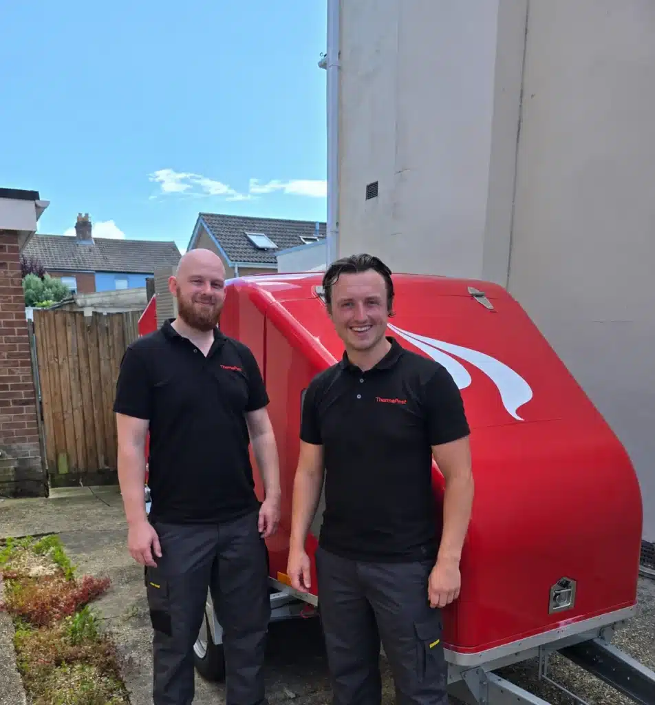 ThermoPest bed bug heat treatment technicians with their heat treatment trailer